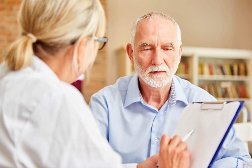A doctor is interviewing a man with dementia